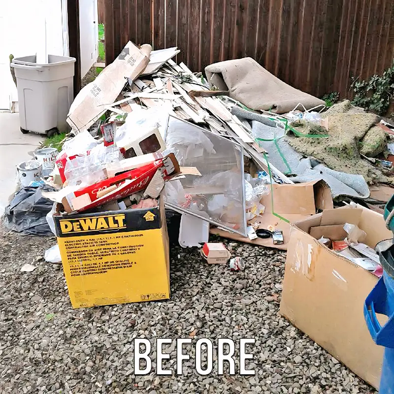 Before, a yard piled with junk, cardboard, and debris