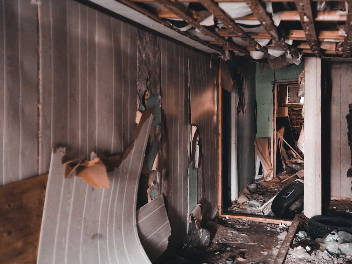 Interior demolition cleanup with torn-out walls and debris