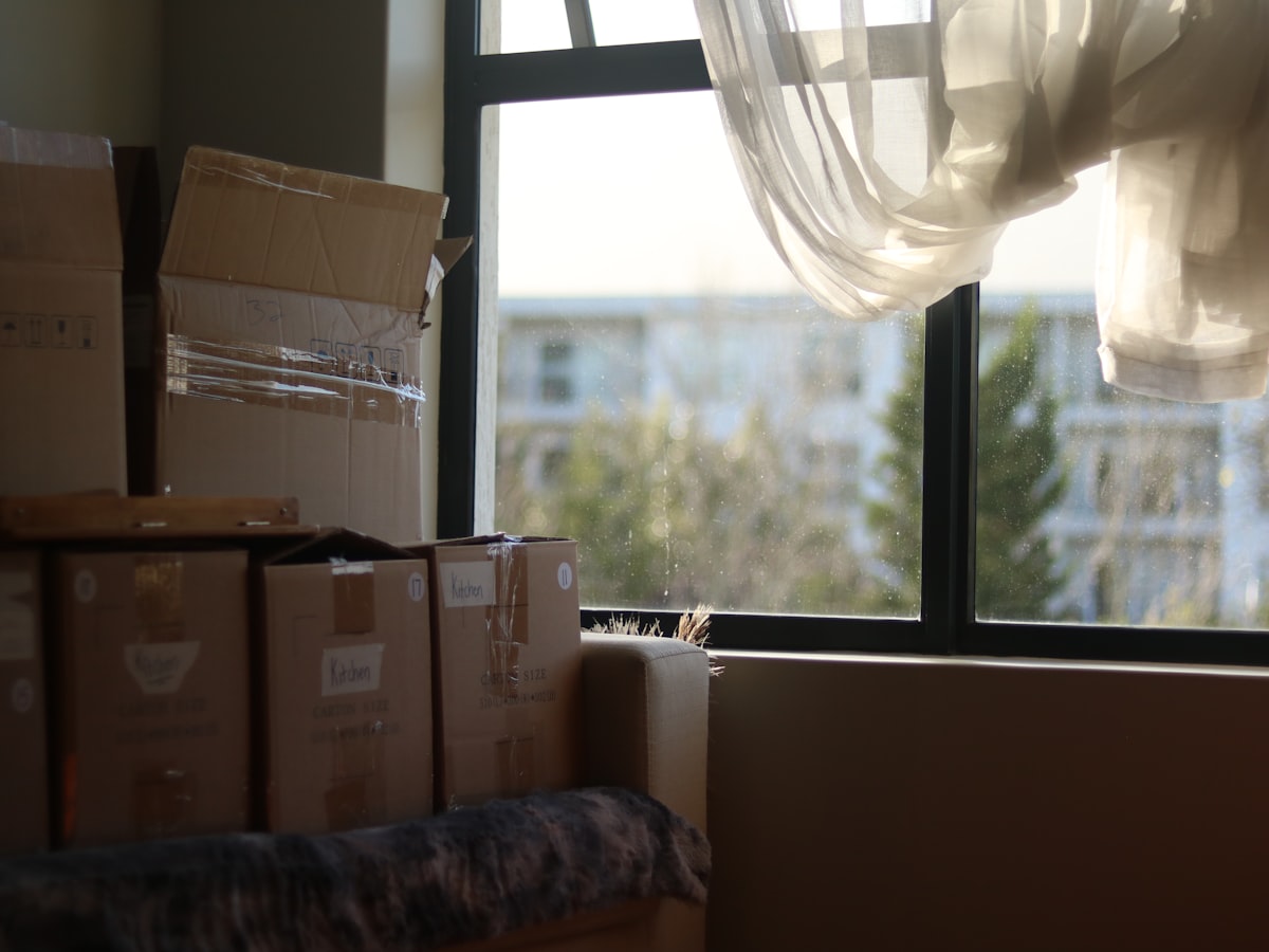 Empty room with cardboard moving boxes during a property cleanout